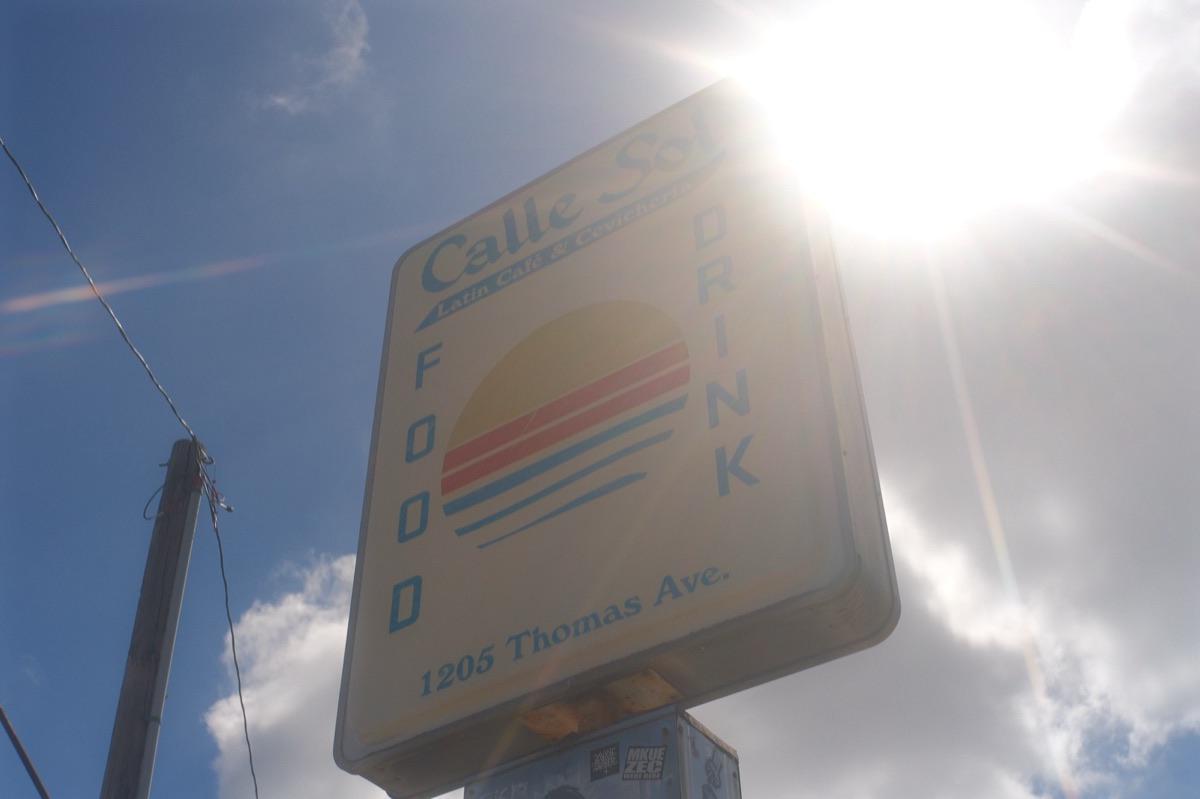 The Calle Sol sign at 1205 Thomas Ave, shot looking up into the sun