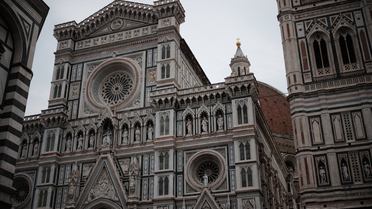 The ornate marble facade and rose windows of Florence Cathedral